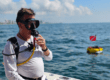 Diver getting ready with the SeaLion dive system on a boat